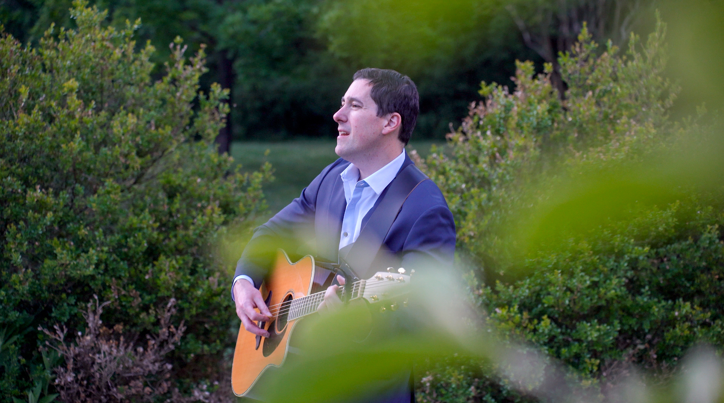 Portrait of Chris Alan with acoustic guitar